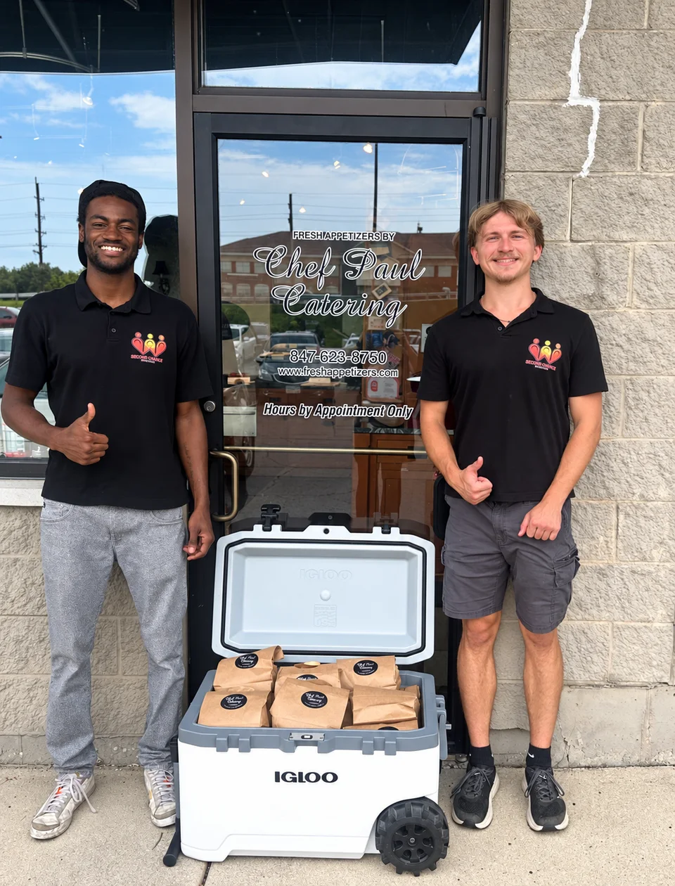 Co-owners Maki, left, and Austin, right, with packed meals for Fresh Start Friday